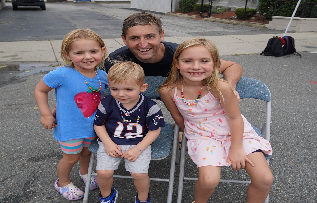 Dr. Milaschewski with 3 of his 5 children after being dunked for charity at last years Fall Street Faire.